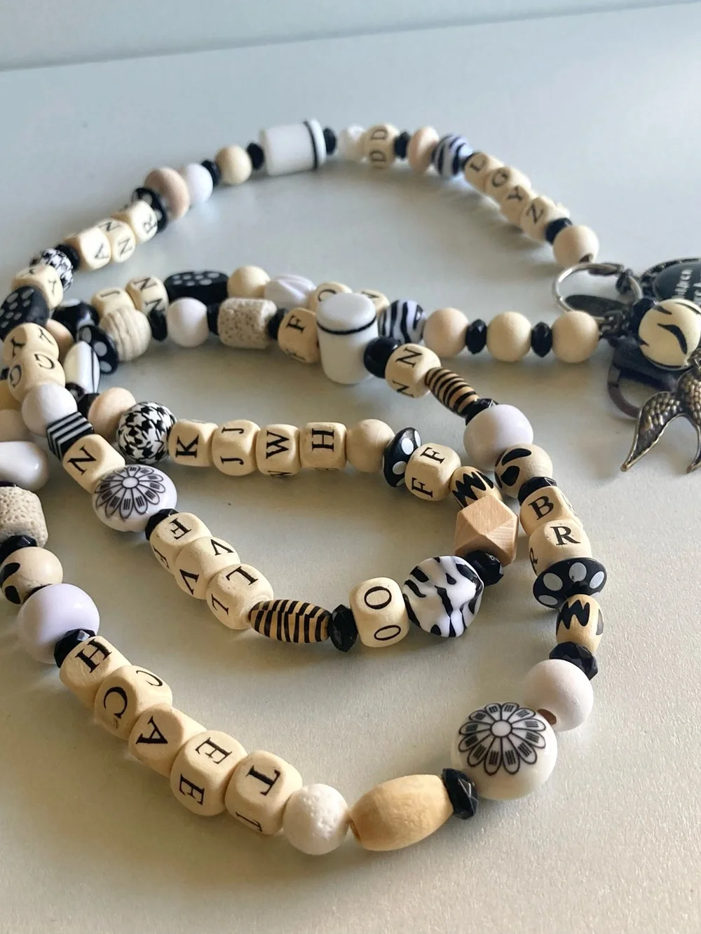 NWOT Plunder Black and Cream Beaded Pendant lanyard with Inspirational Charm